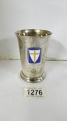 A silver tumbler with Eighth army 1941-1945 emblem.