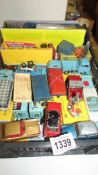 A selection of playworn Corgi toys in original paint, in reproduction boxes.