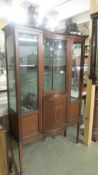 An Edwardian mahogany inlaid display cabinet with concave glass. COLLECT ONLY.
