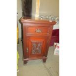 A mahogany cupboard with carved door and side panels, 95 x 56 x 56 cm. COLLECT ONLY.