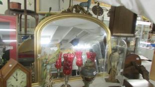 An arched top gilt framed bevel edged mirror. COLLECT ONLY.