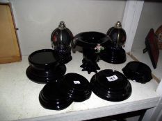 A quantity of black glass (vase) stands