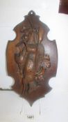 A carved oak hunting themed wall panel.