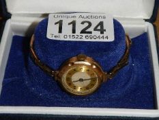 A 9ct gold ladies wrist watch on plated bracelet, in working order.