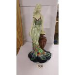 An Old Tupton ware figure of a woman leaning on an urn,