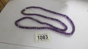 A necklace of natural amethyst beads, birthstone for February.