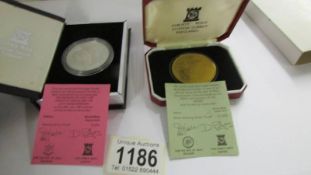 A silver Charles and Diana wedding crown and a silver 200 anniversary of the Derby crown.