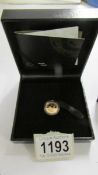 A boxed 50th anniversary gold proof one tenth krugerand.