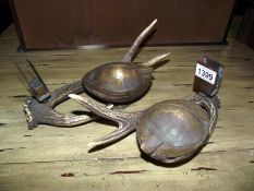 A pair of early 20th-century smokers stands made from antlers and coconut shells, brass mounted,