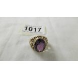 A 9ct gold ring set large amethyst coloured stone, size ). 8 grams.