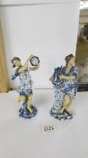 A pair of 19th century blue and white figural vases, 20cm tall, no damage.