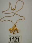 An 18ct gold pendant marked 750 (4 grams) on a 9ct gold chain (3 grams).