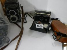 A Rolleicord camera, a cased Instamatic 100 and a Weston Master exposure meter.