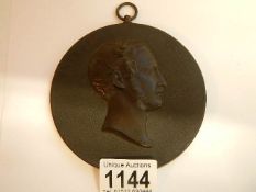 A circular plaque depicting Prince Albert marked Bois Durci on reverse, 11.5 cm diameter.