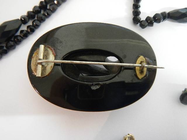 Two black Whitby jet style brooches and a black necklace. - Image 3 of 5