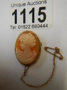 A 9ct gold female profile cameo brooch with safety chain,