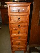 A slim seven drawer pine chest. COLLECT ONLY.