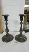 A pair of ornate silver plate candlesticks.