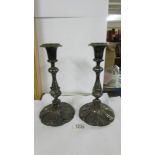 A pair of ornate silver plate candlesticks.