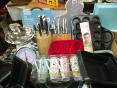 A quantity of kitchenalia, some new baking trays, 2 knife blocks (1 missing 1 knife), new apron,