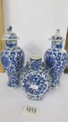 A pair of early Chinese blue & white lidded vases (both lids a/f) and a blue and white flask.
