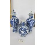 A pair of early Chinese blue & white lidded vases (both lids a/f) and a blue and white flask.