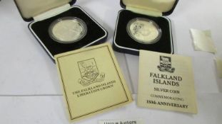 Two Cased Falkland Islands silver crowns, Liberation and 150th anniversary, with certificates.