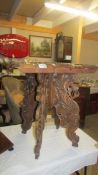 A heavily carved occasional table. COLLECT ONLY.