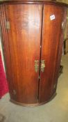 An oak corner cupboard with brass fittings, COLLECT ONLY.