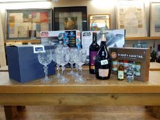 A box of 6 bohemian crystal glasses featuring stags head and two bottles of alcohol, plus two