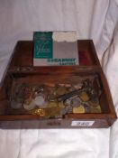 An old wooden box of old mainly foreign coins