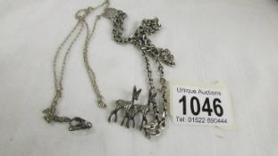 A silver marcasite deer pendant and 2 silver chains.