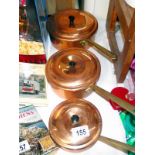 3 copper pans with lids