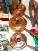 3 copper pans with lids