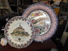 A Limoges 'Mont Saint Michel' plate and a large hand painted Portuguese plate