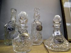 3 cut glass decanters and 1 other with silver plated labels