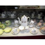 A china tea set plus selection of other part sets and a cake stand