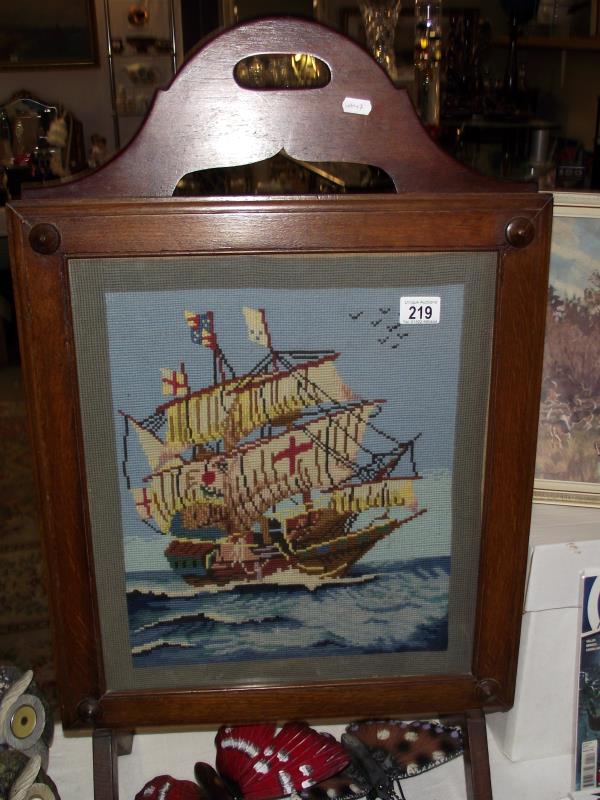 A 1930' to 50's oak framed wool work tapestry of a galleon fire screen, COLLECT ONLY