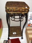 A wrought iron and wicker plant stand, height 41cm, top 21cm x 21cm COLLECT ONLY