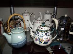 A quantity of tea pots and coffee pots