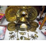 A selection of brass ware including wall plaques, oil lamp, trivet, planter and animals