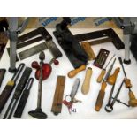 A selection of antique hand tools including a solid cast iron plane