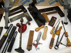 A selection of antique hand tools including a solid cast iron plane