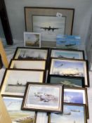 A selection of framed prints and photographs of military ships and planes