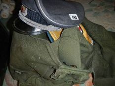 Two military caps, two others, a gun cleaning kit and a bag of army webbing.