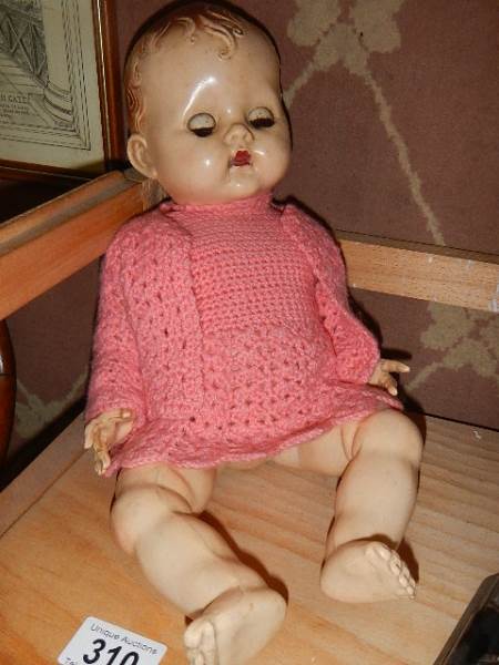 A vintage composition doll.