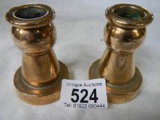 A pair of small contemporary bronze candlesticks.