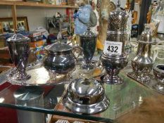 A mixed lot of silver plate condiment sets on trays, bell etc.,