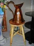 A copper jug and a four legged stools. COLLECT ONLY.