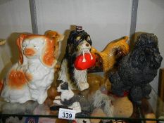 A decanter in the form of a dog and other dog figures.